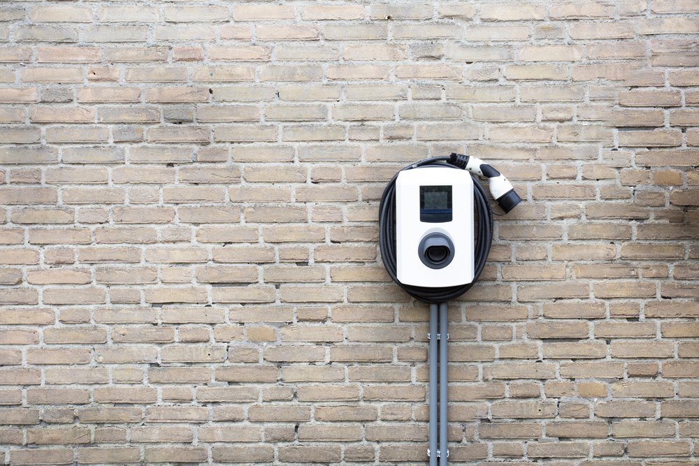 New,Charging,Station,For,Electric,Car,On,Brick,Wall,At